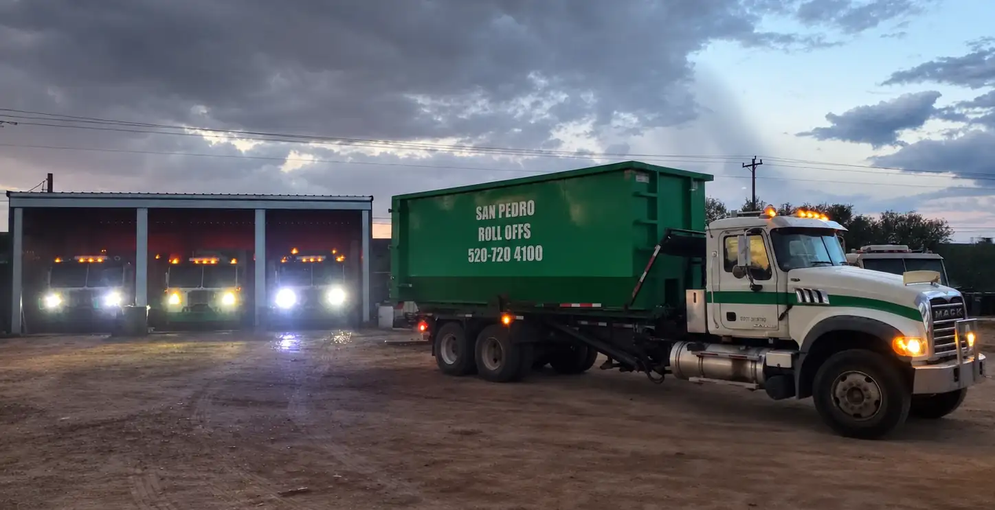 San Pedro Valley Sanitation roll-off truck and fleet at the yard in the evening